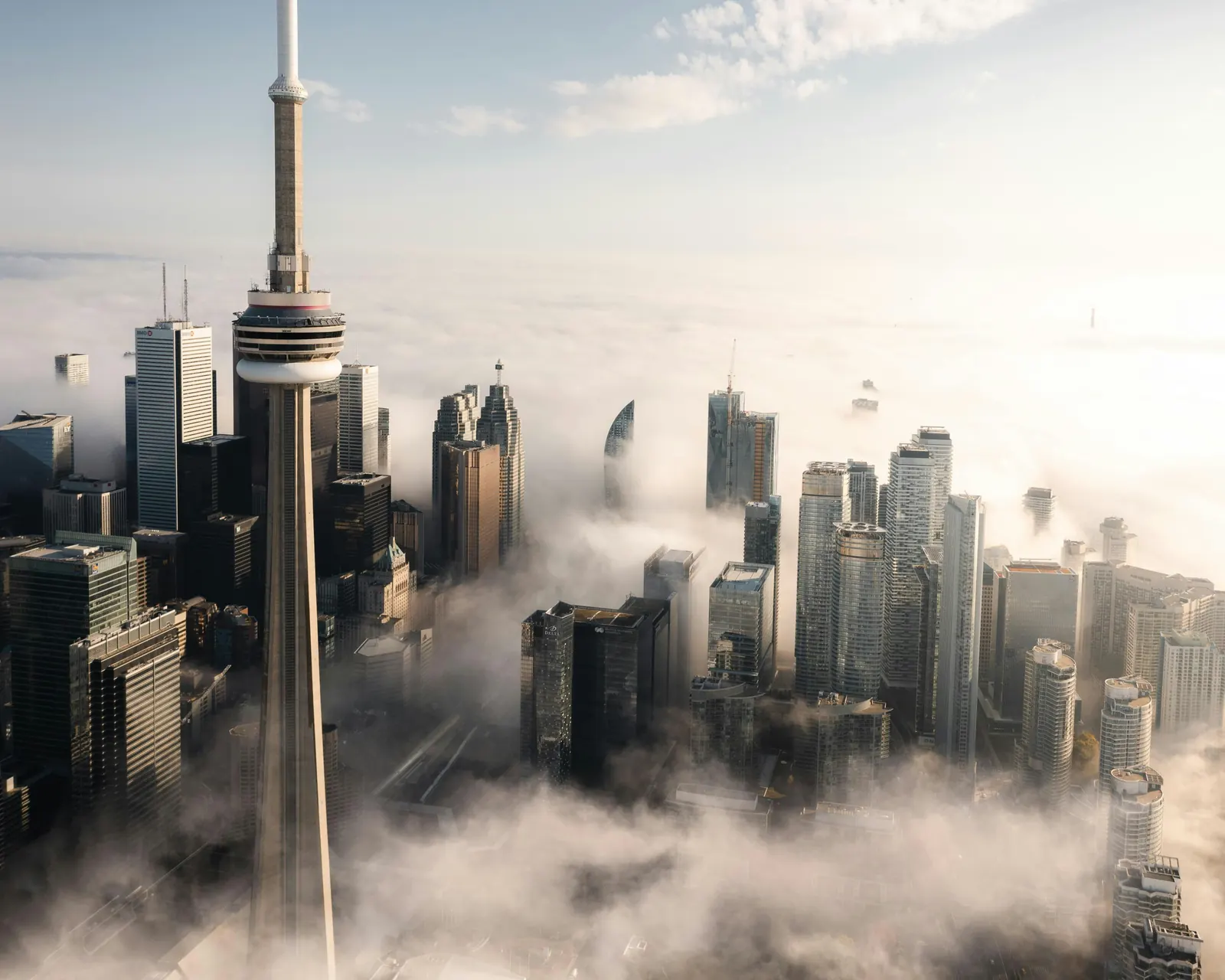Toronto skyline and the CN Tower rising through morning fog